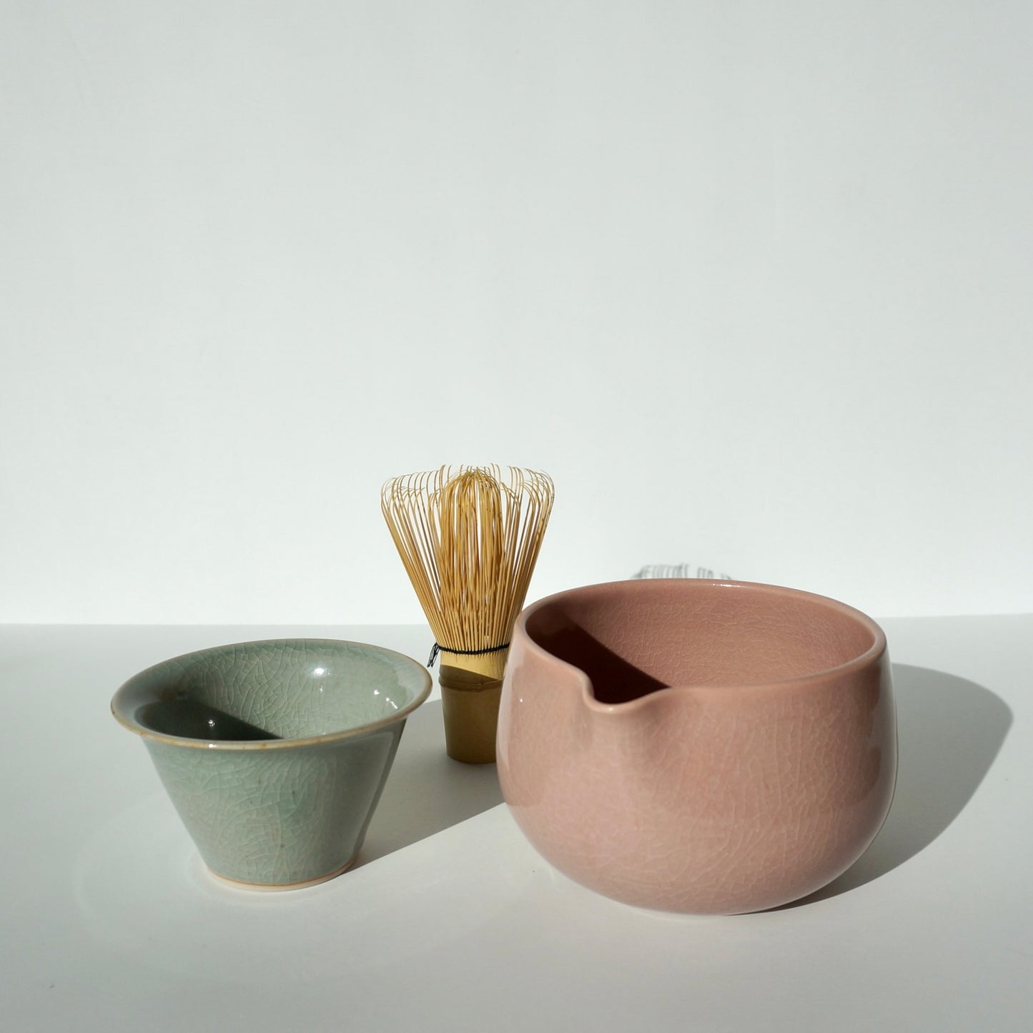 handmade ceramic pink spoutedmatcha bowl and celadon tea cup by Kongji Pottery