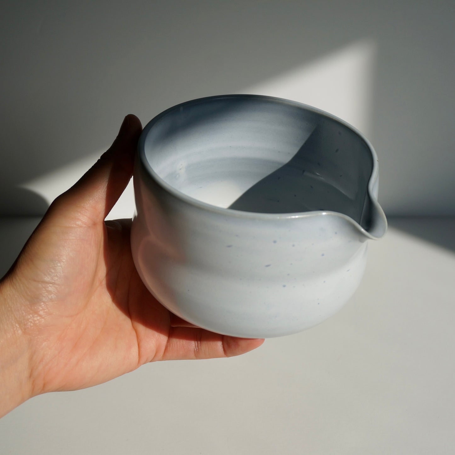 handmade ceramic spouted matcha bowl in light blue glaze by Kongji Pottery