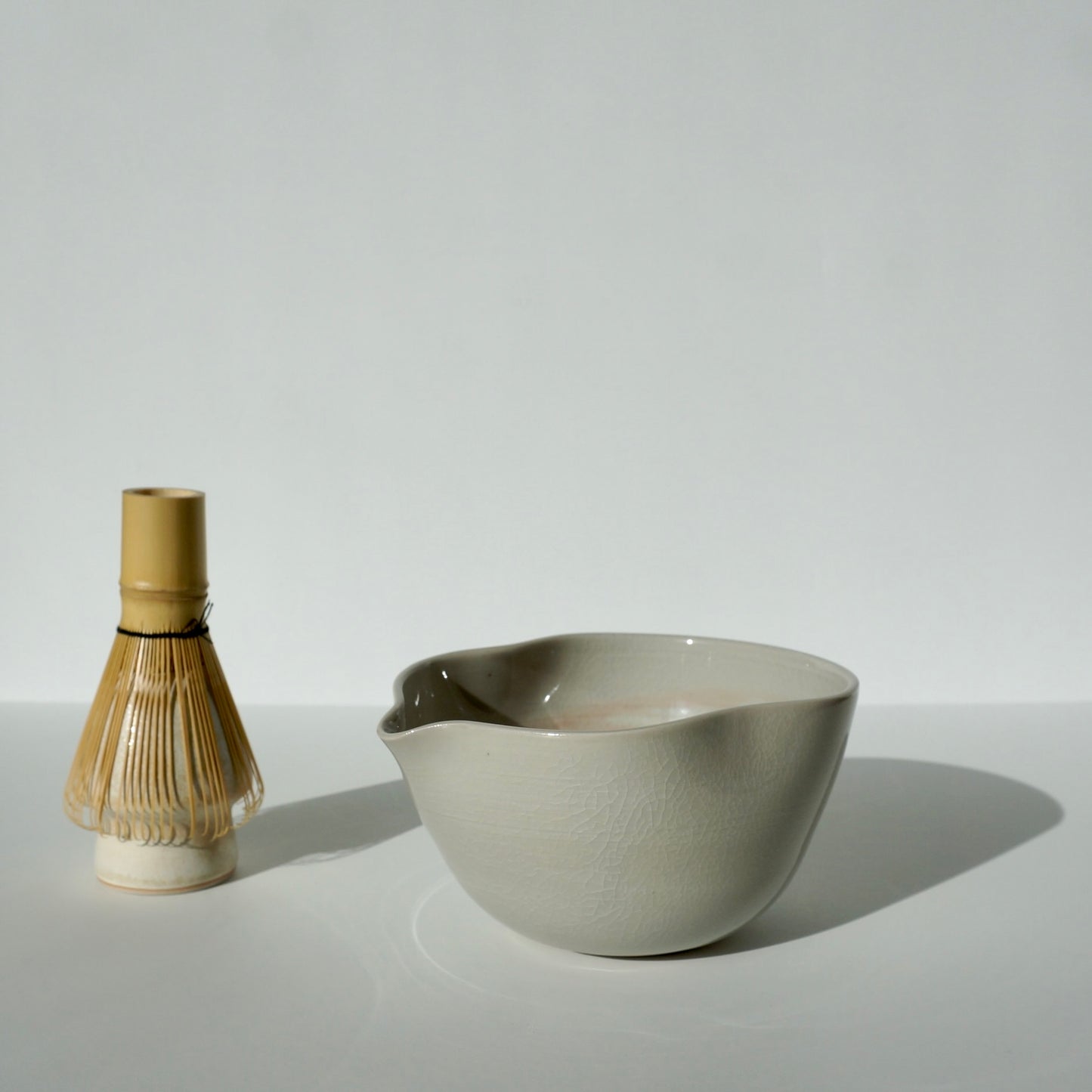 handmade ceramic spouted matcha bowl with wavy rim in blue and pink glaze by Kongji Pottery