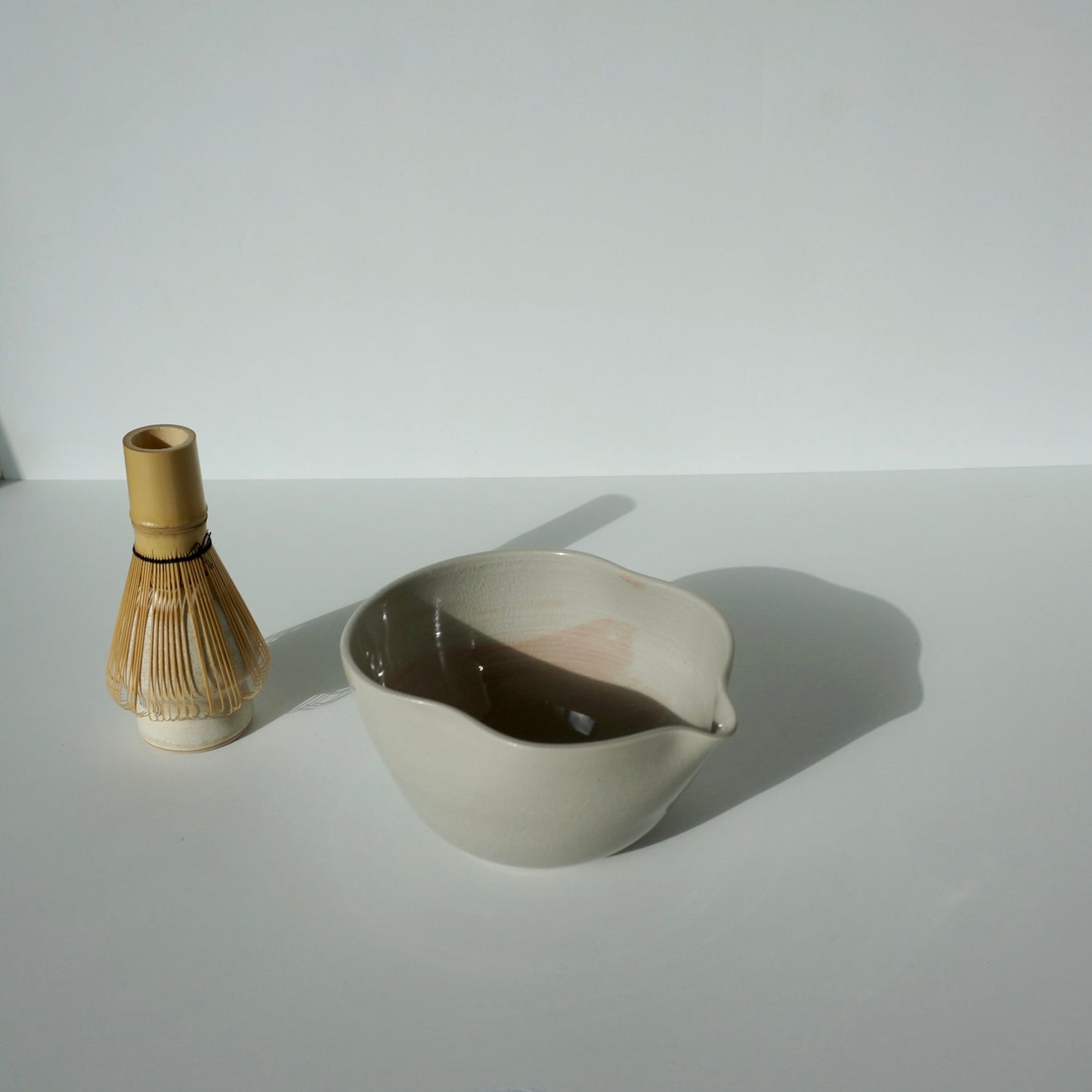 handmade ceramic spouted matcha bowl with wavy rim in blue and pink glaze by Kongji Pottery