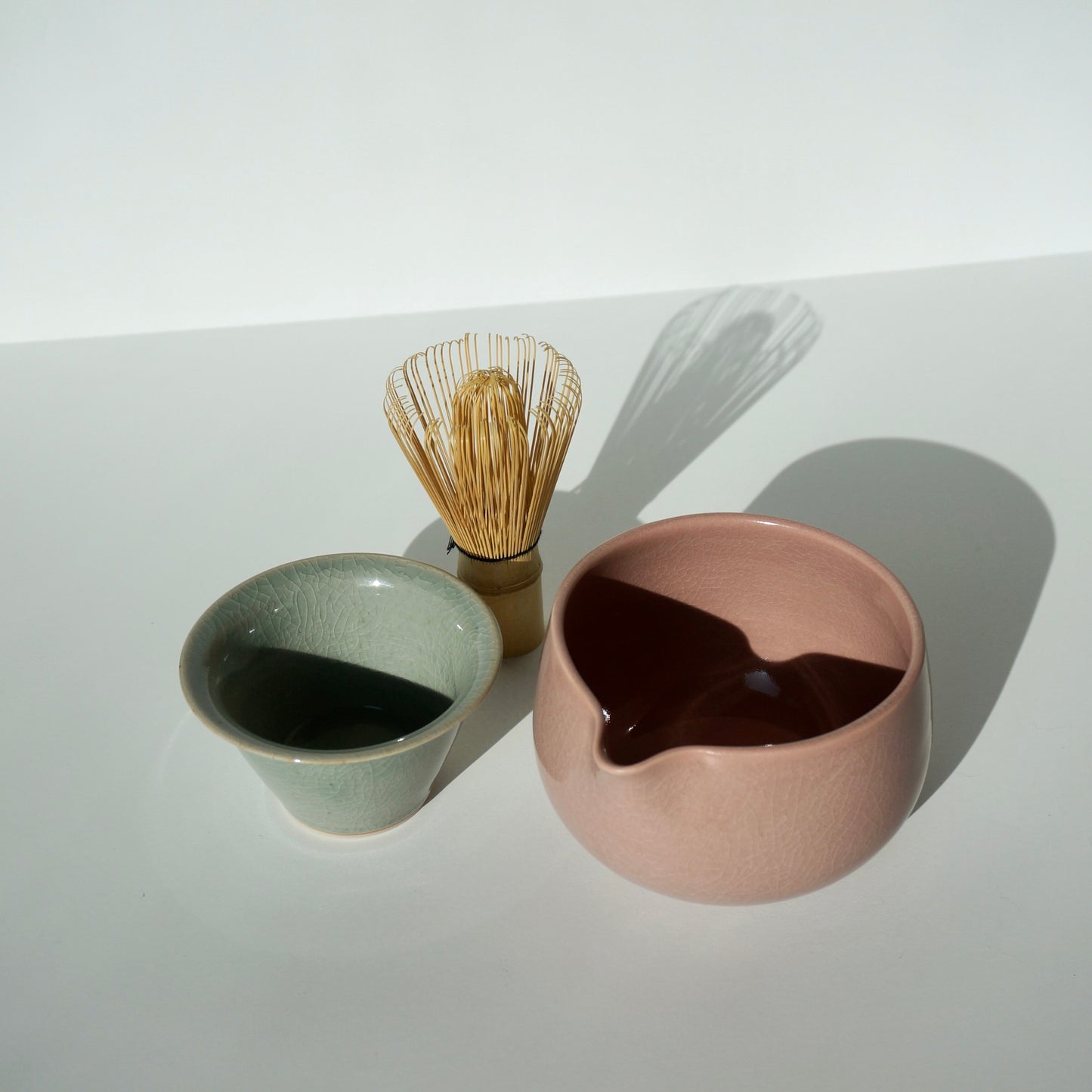 handmade ceramic pink spoutedmatcha bowl and celadon tea cup by Kongji Pottery
