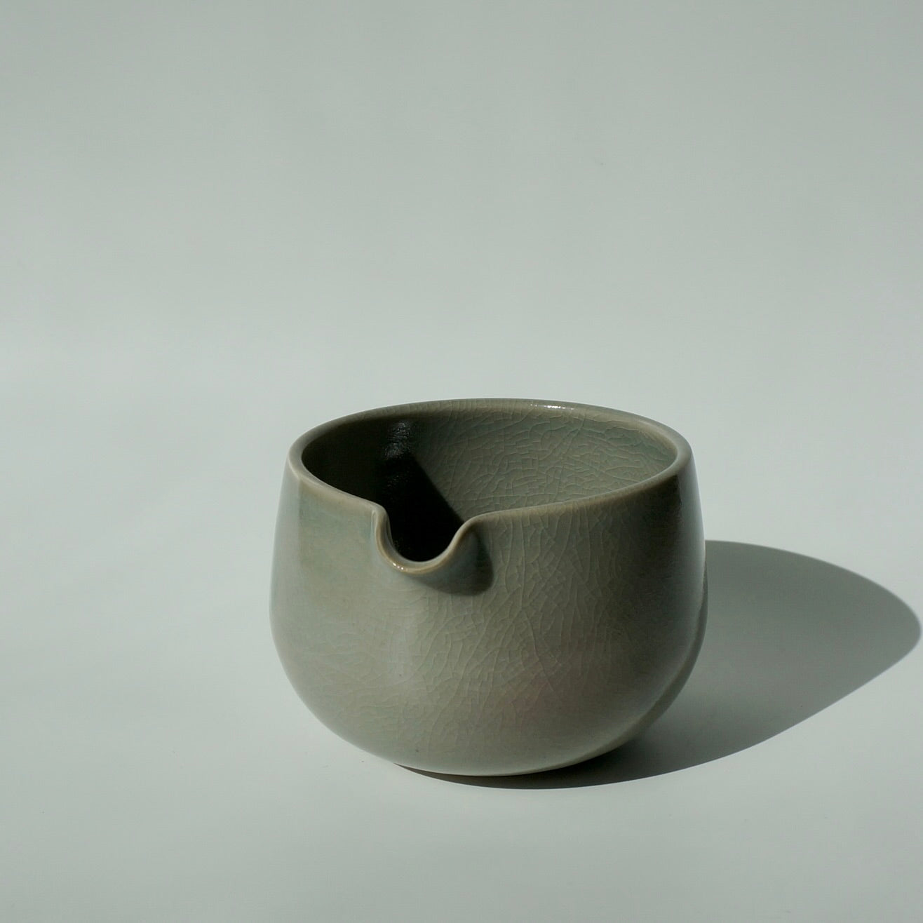 handmade ceramic spouted matcha bowl in crackled celadon green glaze by Kongji Pottery