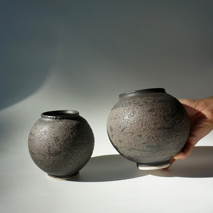 Two black textured handmade ceramic moon jars by Kongji Pottery