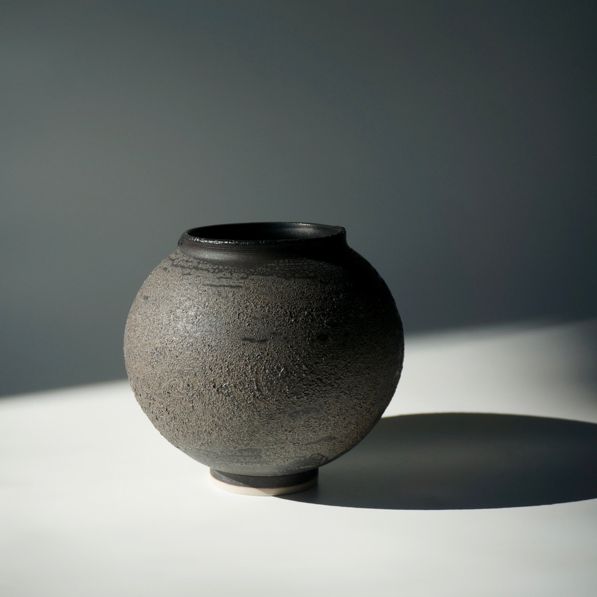 Black textured handmade ceramic moon jar by Kongji Pottery