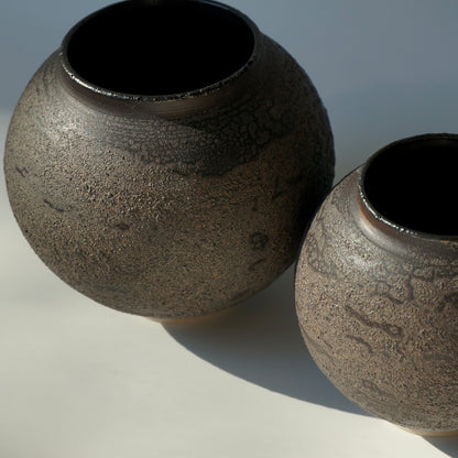 Two black textured handmade ceramic moon jars by Kongji Pottery