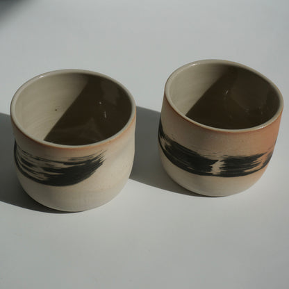 Two handmade ceramic cups with black brushstrokes by Kongji Pottery