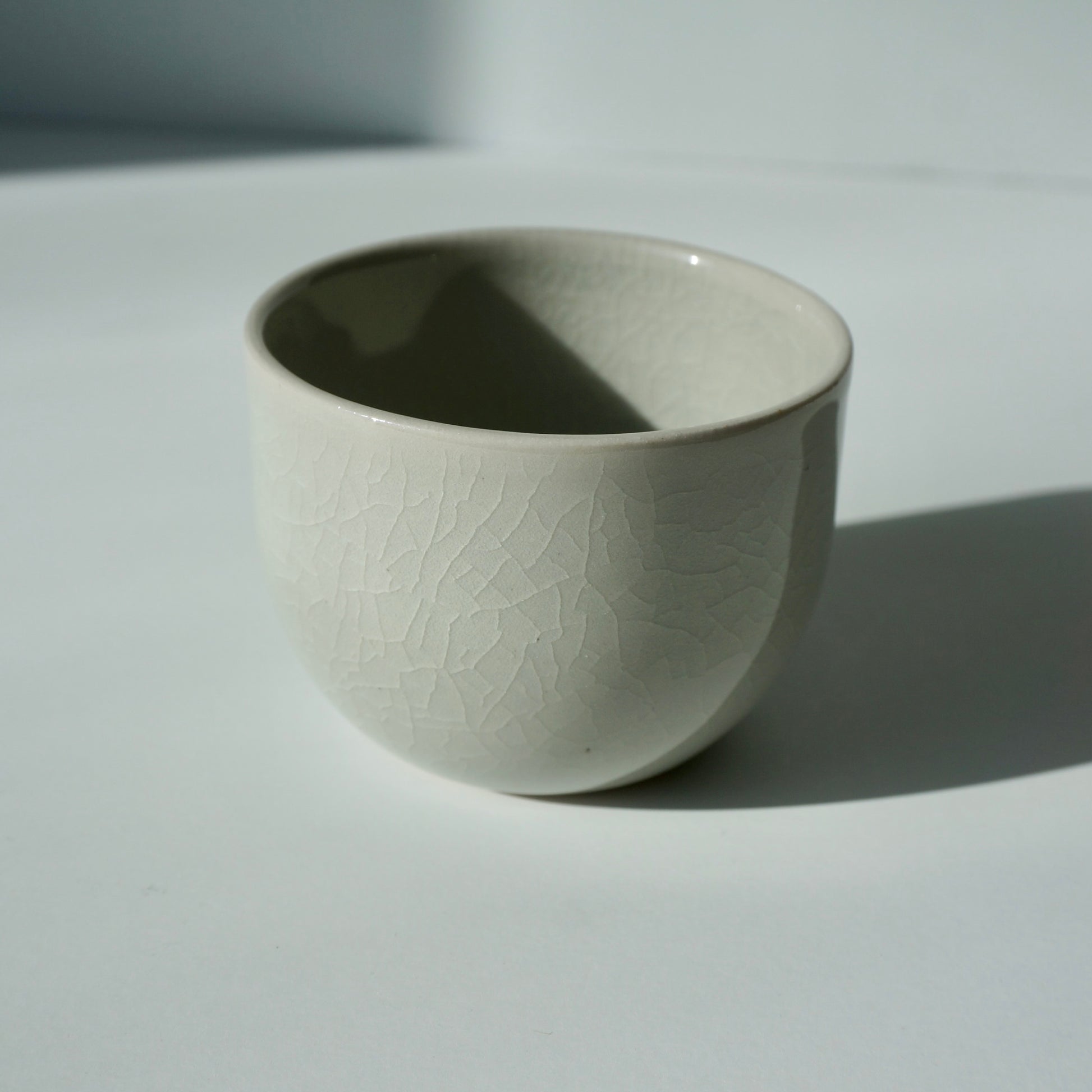 handmade ceramic teacup in glacier glaze by Kongji Pottery