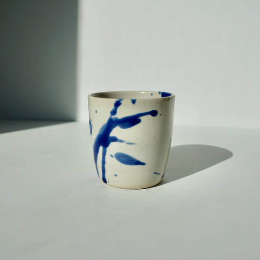 Handmade ceramic small tumbler in glossy white glaze with cobalt splashes by Kongji Pottery