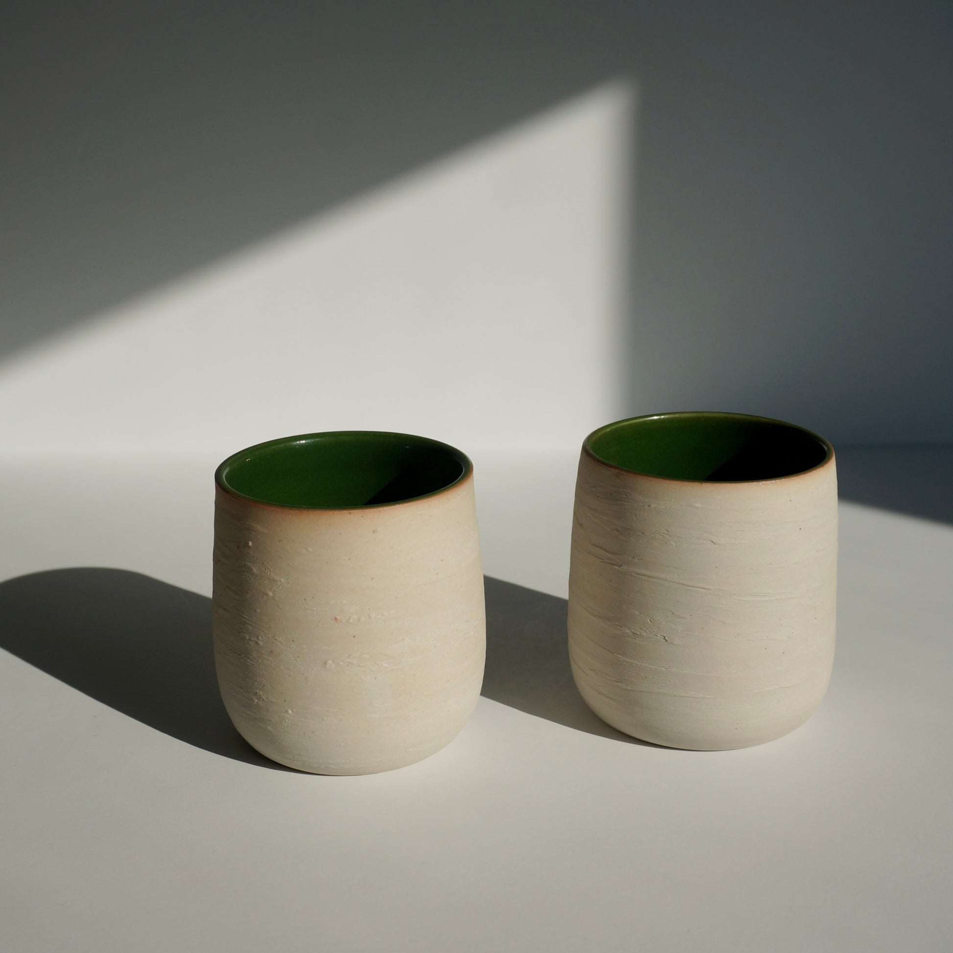 handmade ceramic cups with green interior and textured exterior by Kongji Pottery