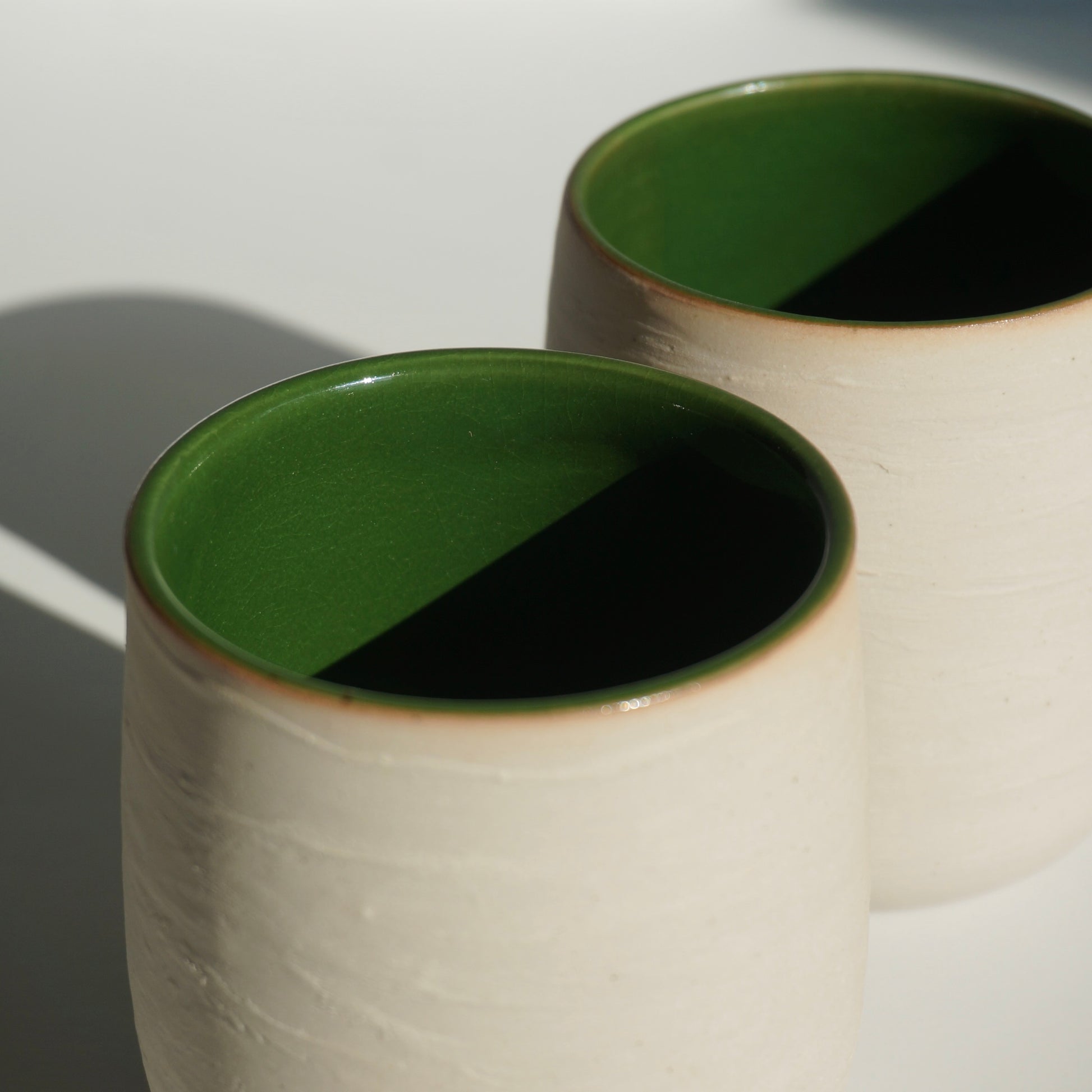 handmade ceramic cups with green interior and textured exterior by Kongji Pottery